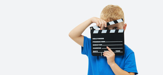 Funny smiling child boy hold film making clapperboard isolated on white background. Studio...
