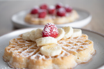 Dessert waffles with raspberries and bananas