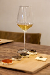 Table decoration with white and black Truffles and white wine. Black and white Truffles on a wooden table.
