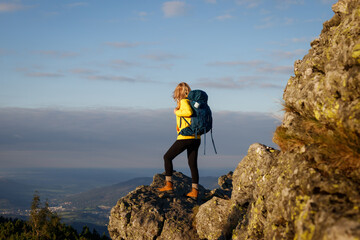 Woman tourist with backpack hiking in nature. Mountain climbing