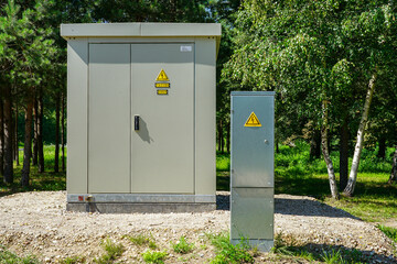 New outdoor electric high voltage distribution cabinet next to low voltage distribution cabinet