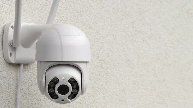 Testing of CCTV camera hanging on wall in supermarket hall closeup. Contemporary digital equipment for video surveillance in business