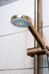 The flow of water from the watering can in the shower, close-up. Taking a shower © Volodymyr