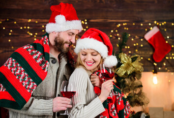Fototapeta na wymiar Romantic couple. Family celebrate winter holiday at home. Romantic evening. Christmas ideas for couples. Romantic date with red wine. Man and woman in love cuddling enjoy intimacy festive atmosphere