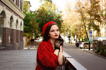 A woman in a red beret looks into the distance