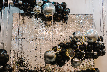 Text party time. Happy New Year 2023. Photo booth was decorated black and silver balloons and led...