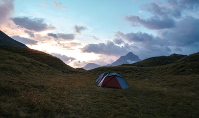 Camping Tent near Bachalpsee in the mountains of Switzerland, Night and Sunset in Swiss Alps
