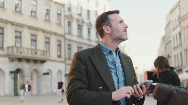 Middle aged man using map app on mobile phone