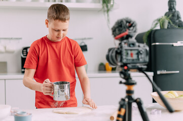 Boy recording culinary blog at home. A child blogger makes a tutorial video.