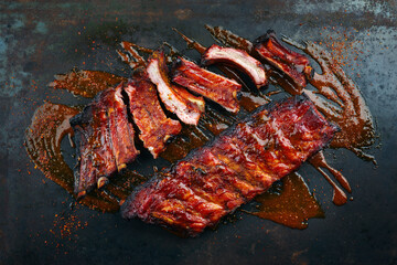 Barbecue pork spare loin ribs St Louis cut with hot honey chili sauce served as top view on a...