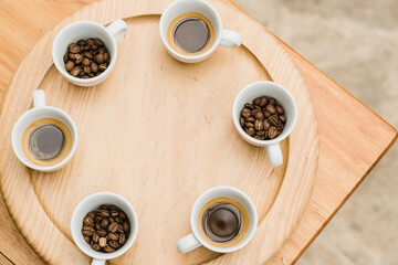 Several cups with coffee, coffee beans in cups, with copy space.