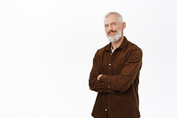 Image of happy old guy with white hair and beard, cross arms on chest, smiling and looking pleased at camera, standing in casual clothes over white background