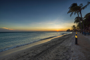 Magnificent view of sunset in Atlantic ocean from sandy beach of island of Aruba.