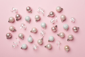 Christmas balls on color background, top view