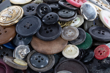 Heap of coloured and antique buttons