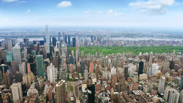 Aerial view of Midtown Manhattan Skyline and Green Central Park.  Iconic Skyscrapers at Daylight. United States. Shot From Helicopter.
