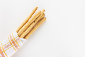 Italian Grissini Breadsticks with olive pieces on white background