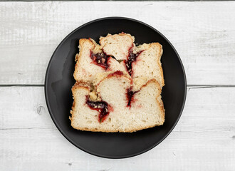Two slices of traditional German red berry cuca on a black plate on a white background. A delicacy from the Silesian region between Poland and Germany quite popular for breakfast and afternoon.