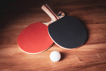 Table tennis rackets and a white plastic balls