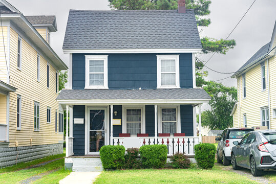  Small Two-story American House With A Well-groomed Lawn In A Seaside Village.