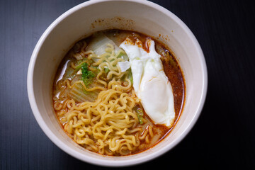 Boiled instant noodles topped with egg and vegetables. Serving menu at an Asian cafe or restaurant