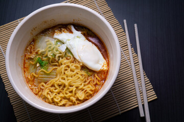 Boiled instant noodles topped with egg and vegetables. Serving menu at an Asian cafe or restaurant