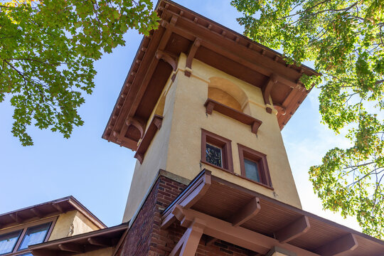 Close Up Architectural View Of An Early 20th Century Spanish Style Church Steeple And Bell Tower With Stucco Wall And Arched Windows