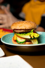 child's handmade cucumber burger. Vertical frame