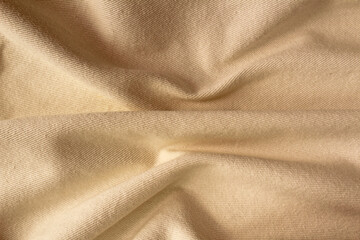 Beige brown crumpled fabric for creative background. Copy space. Vivid textile for wallpaper or design
