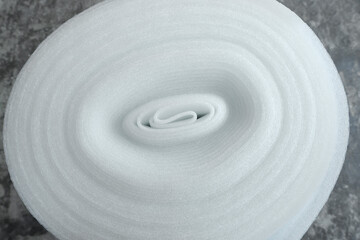 Fototapeta na wymiar Polyethylene foam roll on gray background, above view