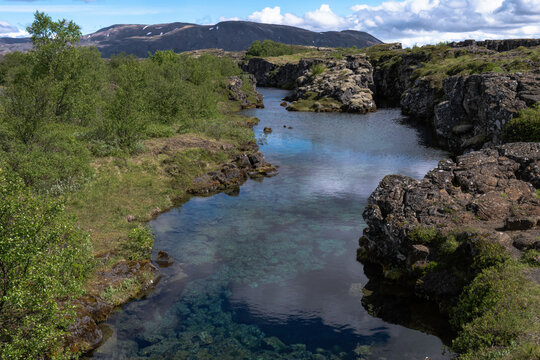 Clouds Reflected In Glacial Water Filling A Fissure Between Tectonic Plates In Thingvellir National Park, Iceland