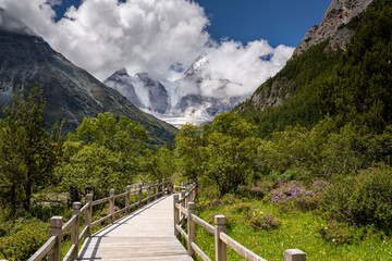 Fototapeta na wymiar Mountain landscape, Snow Mountain and wooden stairway in Daocheng Yading, Sichuan, China. Horizontal image with copy space for text
