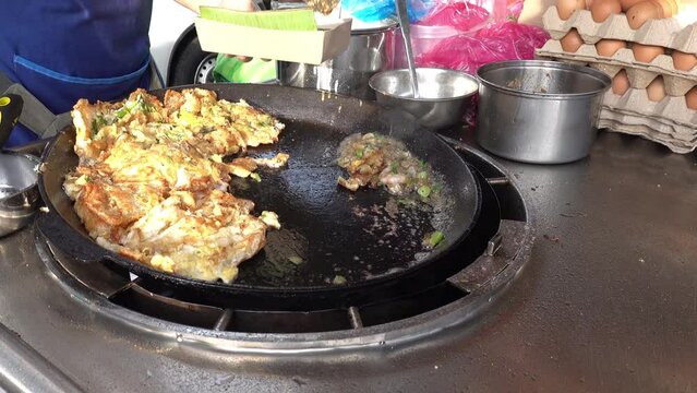 Malacca, Malaysia 07172022-Jonker Street Night shrimp and oyster omelete being served.