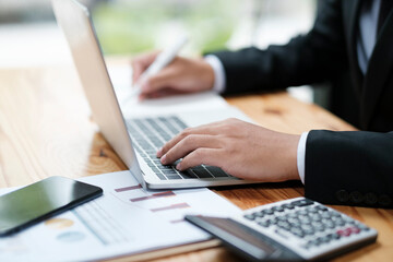 Businessman working at office using laptop.