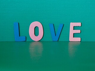 The word love written with letter wooden ,Green background,Valentines Day