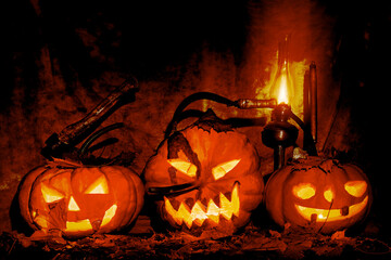 Pumpkins illuminated on the leaves. Autumn still life for Halloween. Jack-o'-lantern.