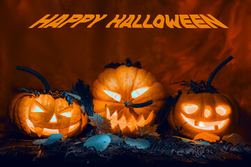 Three glowing pumpkins in foliage for halloween. Autumn holiday card. Jack-o'-lantern.