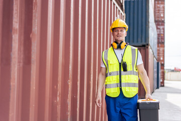 Portrait of Caucasian man worker working in container port terminal. 