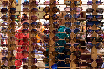 Stall with sunglasses. Lots of colorful eyeglasses. Trade in optics on the market, outdoors.