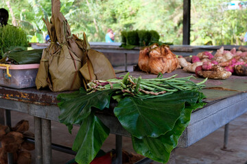 Local produce of leafy greens, sweet potatoes, drinking coconuts on a small fruit and vegetable market stall in Panguna Mine, Bougainville, Papua New Guinea