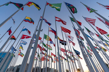 Flags of the different countries against the blue sky