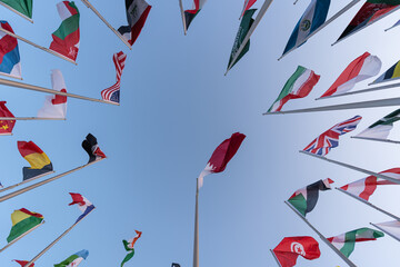 Flags of the different countries against the blue sky