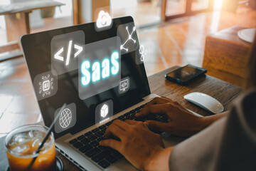 SaaS - software as a service, Businesswoman hand working on laptop to synchronize on SaaS host...