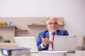 Old male employee in remuneration concept at home