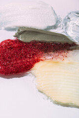 Cosmetic smears and drops. Appearance of the texture of the cream, oil and granules on a white background. Natural skincare products. Beauty concept for face and body care