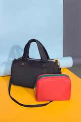 A combination of a red pouch and a black sling bag that is beautiful and modern with a colorful...