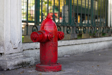 Close-Up Of Fire Hydrant At Sidewalk. Red fire hydrant
