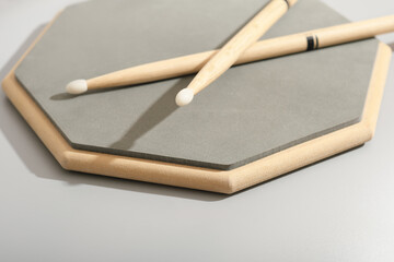 training pad for drummers and a pair of drumsticks, music education, learn and practice, playing drums