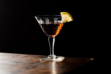 Martinez cocktail a variation of the classic Martini with black background - obrazy, fototapety, plakaty
