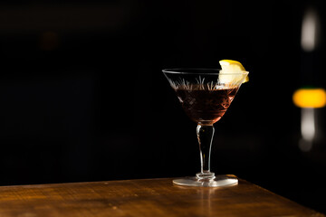 Martinez cocktail a variation of the classic Martini with black background - obrazy, fototapety, plakaty